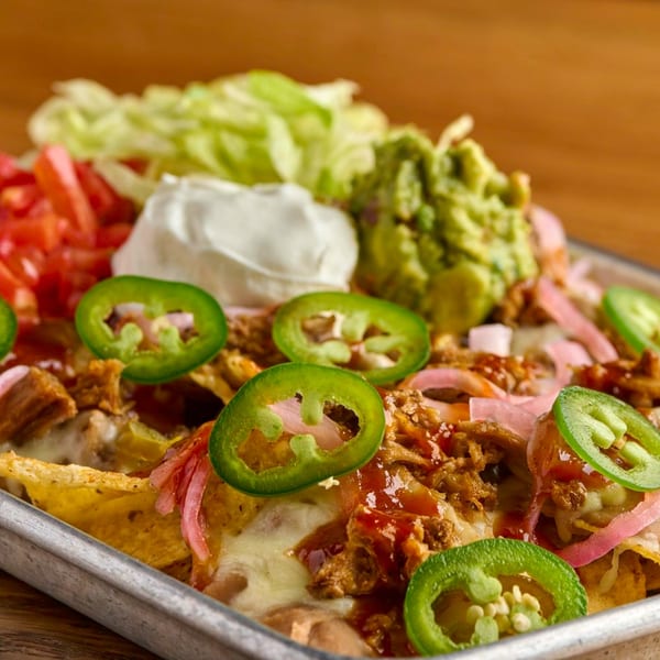 Salsaria's loaded nachos with melted cheese, meat, jalapeños, guacamole, sour cream, and tomatoes.